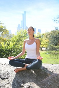 Woman doing yoga exercises in Central Park, NYC